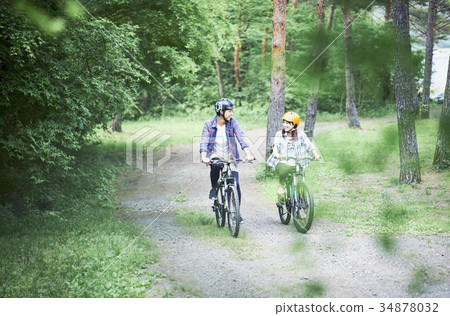 Couple riding a mountain bike 34878032