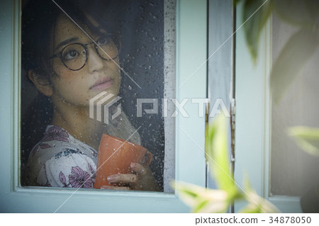 Rainy day woman spending at home 34878050