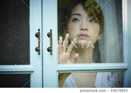 Rainy day woman spending at home 34878065