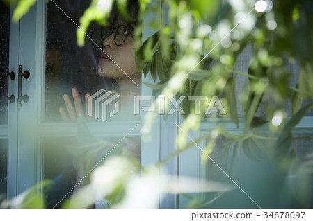 Rainy day woman spending at home 34878097