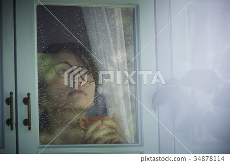 Rainy day woman spending at home 34878114
