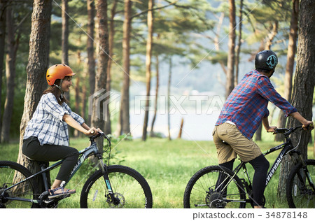 Couple riding a mountain bike Couple riding a mountain bike 34878148