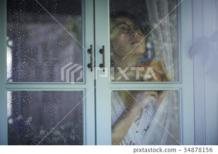 Rainy day woman spending at home 34878156