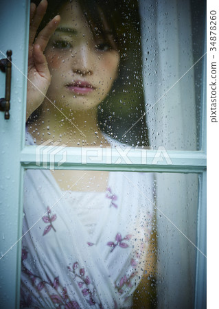 Rainy day woman spending at home Rainy day woman spending at home 34878260
