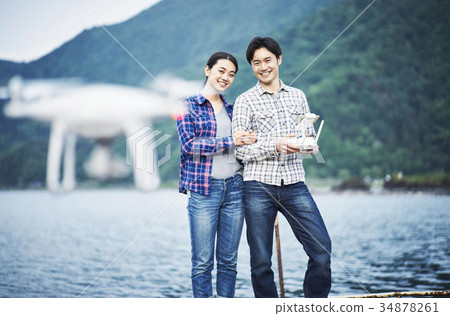 Couple taking a selfie with drone Couple taking a selfie with drone 34878261