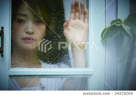 Rainy day woman spending at home 34878269