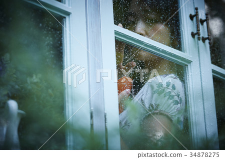 Rainy day woman spending at home Rainy day woman spending at home 34878275