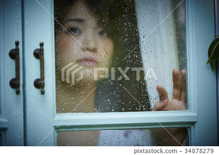 Rainy day woman spending at home 34878279