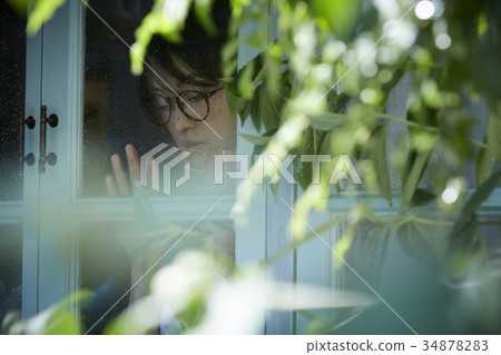 Rainy day woman spending at home 34878283