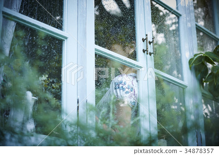 Rainy day woman spending at home 34878357
