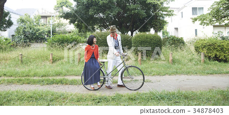 Senior couple riding a bicycle 34878403