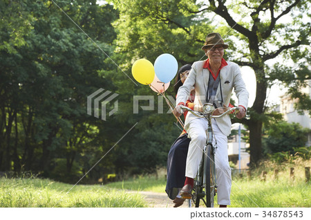 Senior couple riding a bicycle 34878543