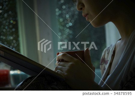 Rain and silence Woman relaxing at home 34878595