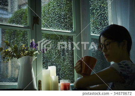 Rain and silence Woman relaxing at home 34878672
