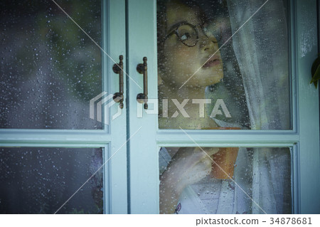 Rainy day woman spending at home 34878681