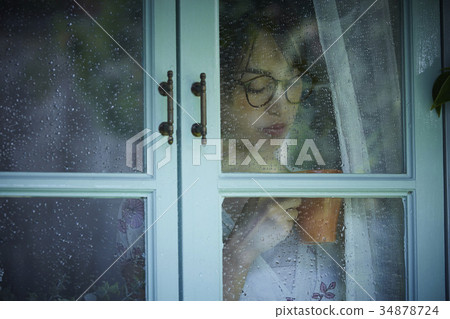 Rainy day woman spending at home 34878724