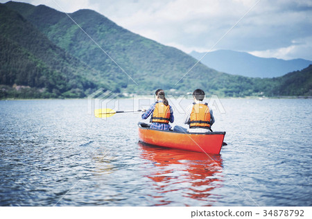 Couple rowing canoe 34878792