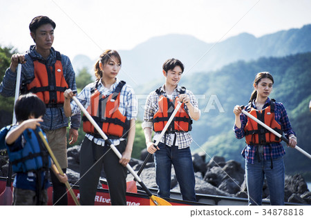Family rowing a canoe 34878818