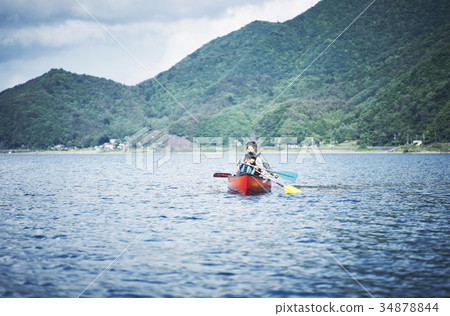 Family rowing a canoe 34878844