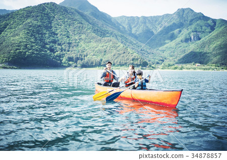 Family rowing a canoe 34878857
