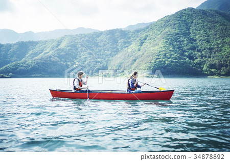Couple rowing canoe 34878892