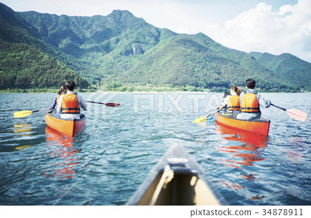 Family rowing a canoe 34878911