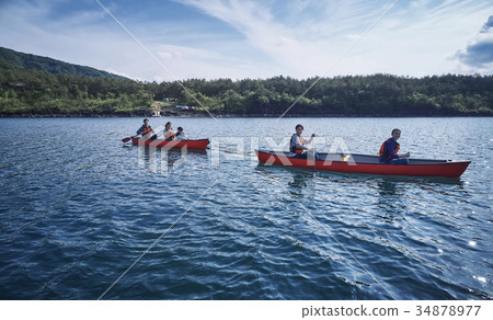 Family rowing a canoe Family rowing a canoe 34878977