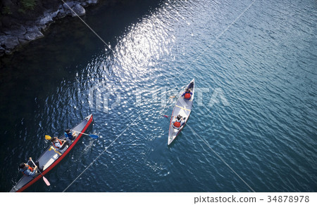 Family rowing a canoe Family rowing a canoe 34878978