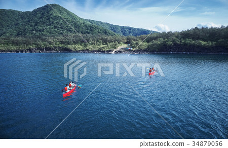 Family rowing a canoe 34879056
