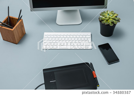 The gray desk with laptop, notepad with blank 34880387