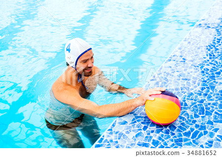 Water polo player in a swimming pool. 34881652