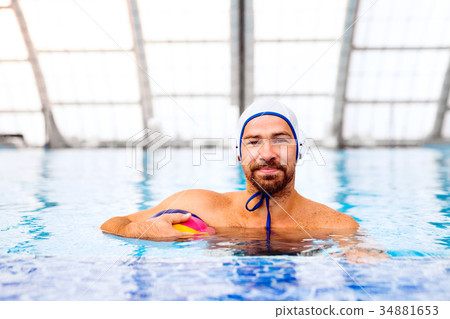 Water polo player in a swimming pool. Water polo player in a swimming pool. 34881653