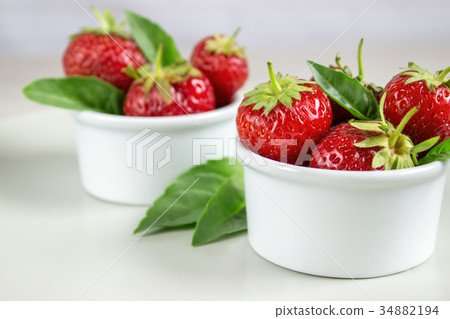 Ripe strawberries anf mint in a bowl Ripe strawberries anf mint in a bowl 34882194