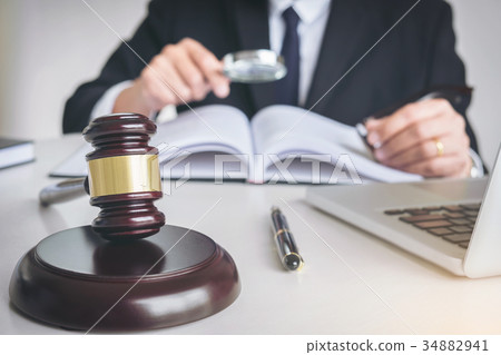 Close up of gavel, Male lawyer or judge working with Law books, 34882941