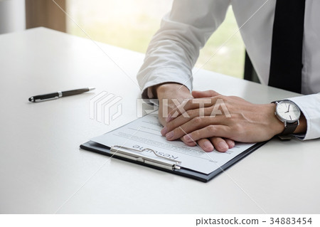 Interviewer or Board reading a resume during a job interview, Em 34883454