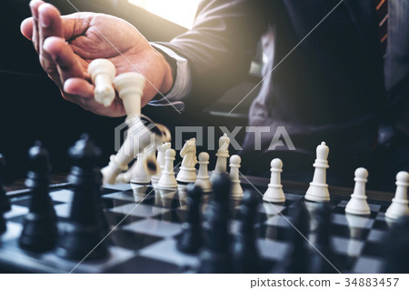 Close up of hands confident businessman colleagues playing chess Close up of hands confident businessman colleagues playing chess 34883457