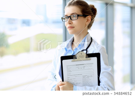 Medical physician doctor woman over blue clinic Medical physician doctor woman over blue clinic 34884652