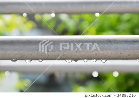 drop of water on aluminum clothes line after rain 34885210