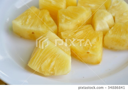 pineapple slice on white dish 34886841