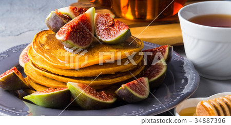 Stack of pumpkin pancakes with figs and honey 34887396
