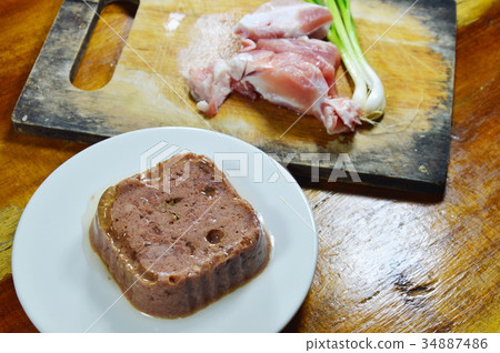 dog premium wet food and fresh raw pork on block 34887486