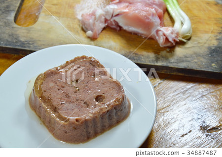 dog premium wet food and fresh raw pork on block 34887487