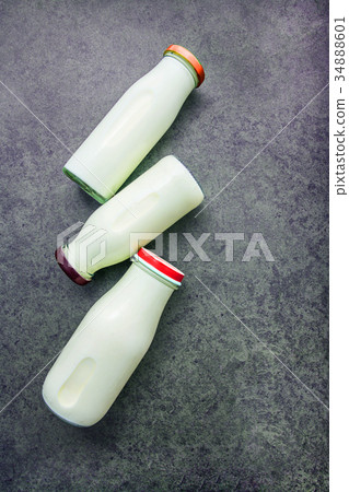 Milk bottle on dark stone background. Milk bottle on dark stone background. 34888601