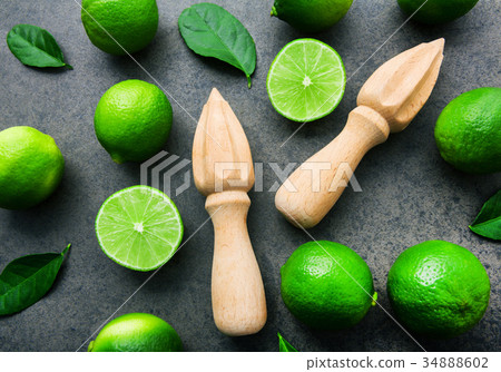 Fresh limes and wooden juicer on  background.  34888602