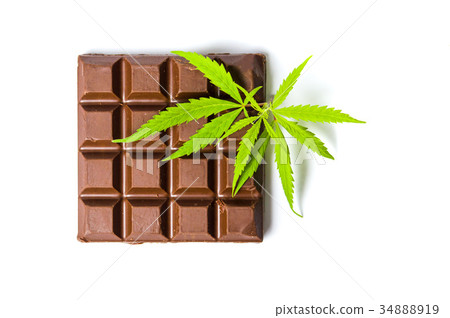 Chocolate block with marijuana leafs isolated 34888919