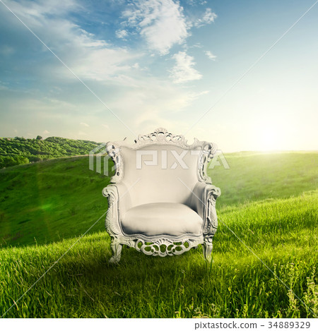Arm chair and landscape on sunset 34889329
