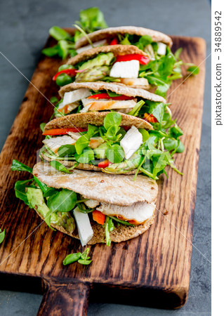 Pita sandwiches stuffed with chicken, vegetables Pita sandwiches stuffed with chicken, vegetables 34889542
