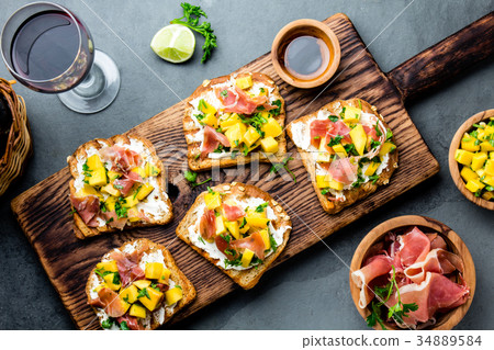 Toasts with cream cheese, ham jamon serrano and 34889584