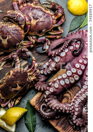 Seafood octopus. Whole fresh raw octopus and crabs Seafood octopus. Whole fresh raw octopus and crabs 34889917