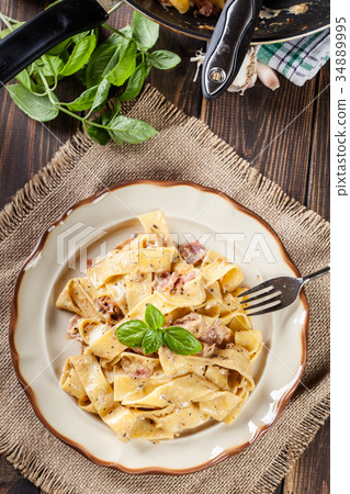 Pappardelle pasta with prosciutto and cheese sauce 34889995